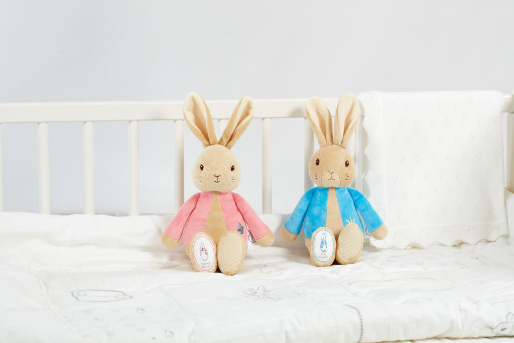 An image of two toys on a bed -part of the award winning World of Peter Rabbit product range